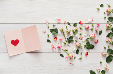 Wall Mural - Valentine background with pink rose flowers heart, handmade paper card on white rustic wood.