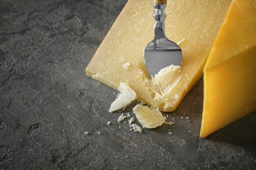 Wall Mural - Delicious cheese with knife on grey background