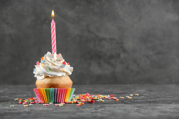 Wall Mural - Birthday cupcake with candle on table