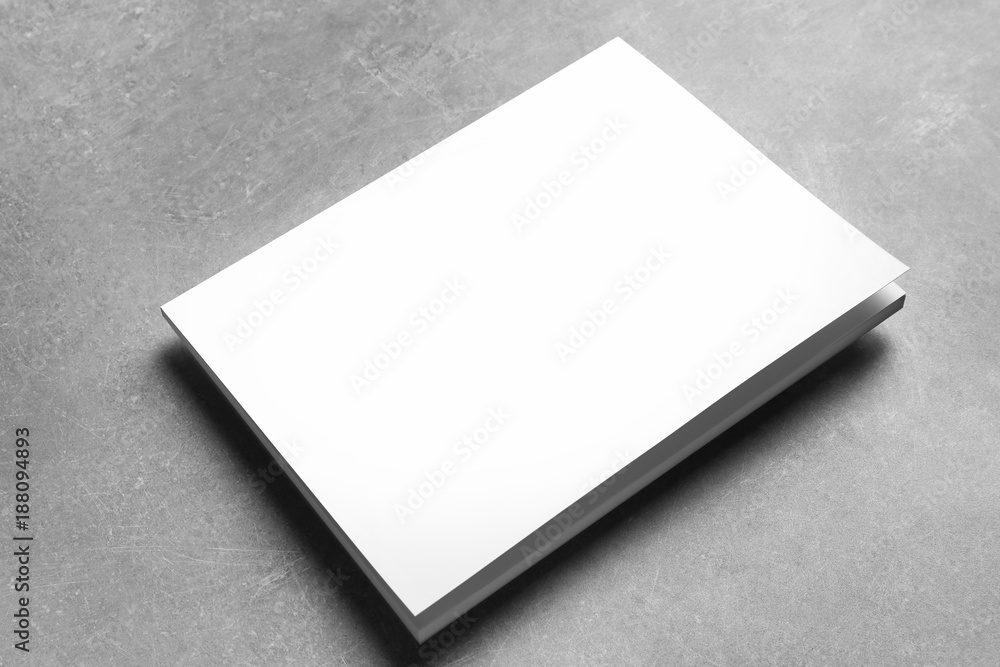 Book with blank cover on grey background. Mock up for design