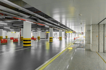 interior of parking garage with car and vacant parking lot in parking building