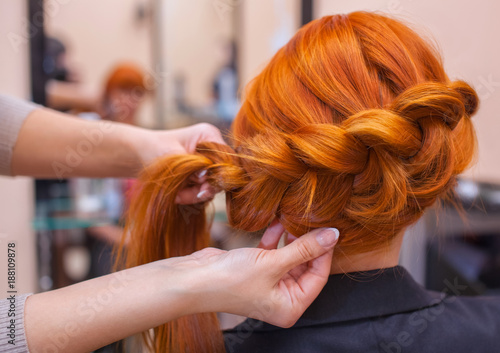 Beautiful Girl Hairdresser Weaves A Braid In A Beauty Salon