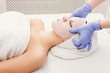 © Prostock-studio - Woman gets face mask by beautician at spa