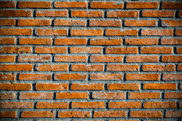 Closeup photo. Background of Old brick wall. Black vignette at the edge of photo.