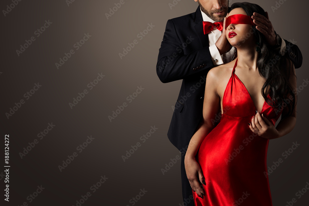 Couple Love Kiss, Sexy Blindfolded Woman Dancing in Red Dress and Elegant Man in Suit - obrazy, fototapety, plakaty 