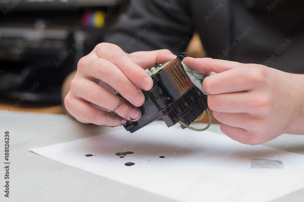 Stock-Foto „The repair specialist keeps a broken printhead from the ...