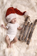 Yawning newborn child wearing a santa's hat