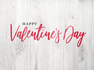 Wall Mural - happy valentine's day holiday red calligraphy over rustic whitewashed wood background