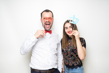 Wall Mural - young couple friends pose photo booth funny props