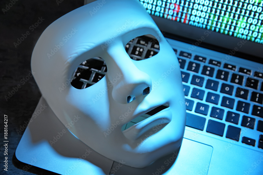 White mask on laptop keyboard, closeup