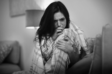 Depressed young woman with smeared makeup at home