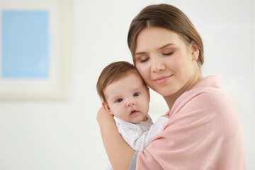 Sticker - Young mother with her cute little baby at home