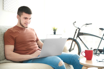 Sticker - Young man using laptop at home