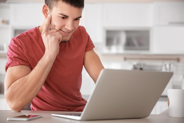 Sticker - Young man using laptop at home