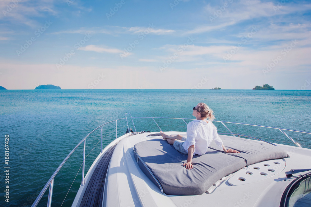 beautiful woman enjoying luxurious yacht cruise, sea travel by luxury boat - obrazy, fototapety, plakaty 