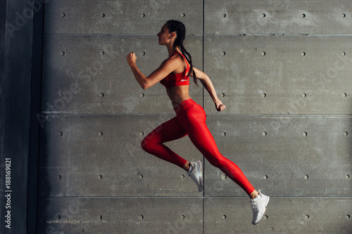 Fotografie, Obraz Side view fit woman doing cardio training.