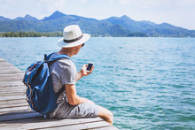 Tourist Traveler Using Mobile Phone, Smartphone App For Traveling