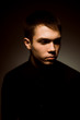 © ruslan1117 - young guy on a dark studio background