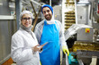 © pressmaster - Succesful workers of seafood producing factory in uniform looking at camera at work