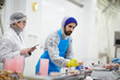 © pressmaster - Control staff in uniform checking weight and quality of seafood during processing