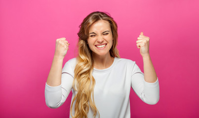 Successful woman raising hand in success gesture