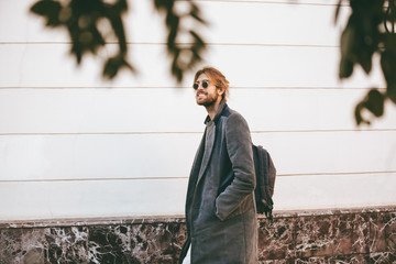 Portrait of a smiling bearded in earphones man