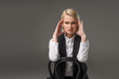 © LIGHTFIELD STUDIOS - portrait of young stylish woman sitting on chair and looking at camera isolated on grey