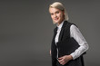 © LIGHTFIELD STUDIOS - portrait of stylish businesswoman with notepad isolated on grey