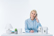 © LIGHTFIELD STUDIOS - portrait of smiling real estate agent talking on smartphone at workplace with house model