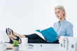 © LIGHTFIELD STUDIOS - focused real estate agent looking at notebook in hands at workplace