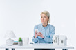 © LIGHTFIELD STUDIOS - portrait of real estate agent using smartphone at workplace with house model