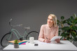 © LIGHTFIELD STUDIOS - portrait of pensive businesswoman with tablet at workplace isolated on grey