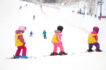 Wall Mural - little kids skiing in ski resort