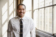 © Monkey Business - Young Hispanic businessman smiling to camera, close up