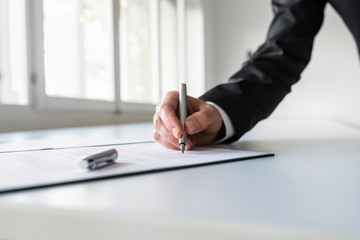 Wall Mural - Man in business suit signing contract