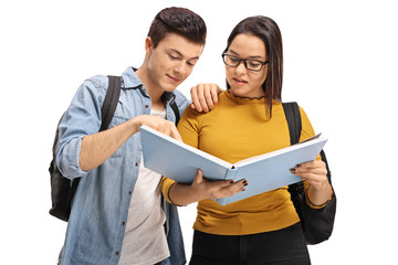 Wall Mural - Teenage students reading a book together