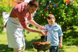 © Syda Productions - father and son cooking meat on barbecue grill