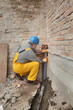 © sima - Plumber at construction site installing sewerage tube, home renovation