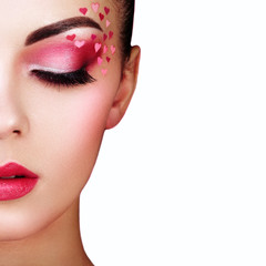Wall Mural - face of beautiful woman with holiday makeup heart. valentine's day make-up. lips in pink lipstick. m