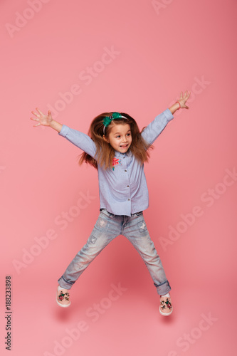 Full Length Picture Of Joyful Carefree Child Jumping And Throwing Hands Up In The Air Being Isolated Over Pink Background Buy This Stock Photo And Explore Similar Images At Adobe Stock
