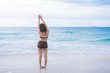 © saksit - Beach summer holidays woman in happy freedom concept with arms raised out in happiness. Woman model wearing white bikini and beach hat on Big Island, Hawaii.
