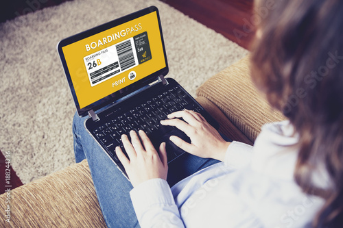Fotografía Woman printing flight boarding pass while sitting at home.