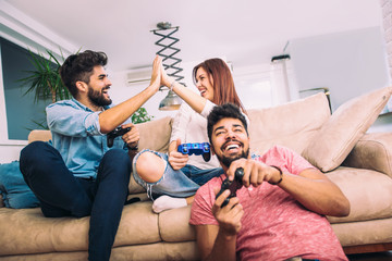 Wall Mural - Group of friends play video games together.