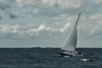 Canvas Print - Blue sailboat at storm