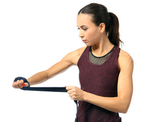 Wall Mural - Boxer woman applying wrist wraps on white background