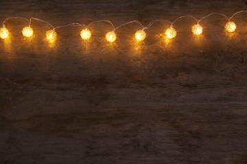 Wall Mural - Festive Christmas lights on wooden background