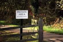 Wooden Gate On A Road Through Forest Or Woodland, With A Sign Saying "PRIVATE AREA No Admittance"