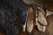 © Mike Persico - Close-up of smoked barbecue brisket on wooden surface