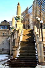 Stone Steps Alongside A Bridgehouse For Chicago River Bridge And Light Posts With Globe Shaped Bulbs.