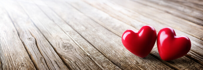 Wall Mural - couple of hearts in love on vintage wooden table - valentines day
